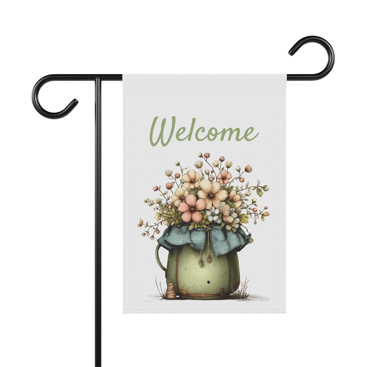 Garden flag on a black metal stand printed with green script Welcome text above a rustic sage green jug overflowing with pastel wildflowers
