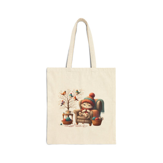 Canvas tote bag with a cozy cat sitting in an armchair with yarn and birds