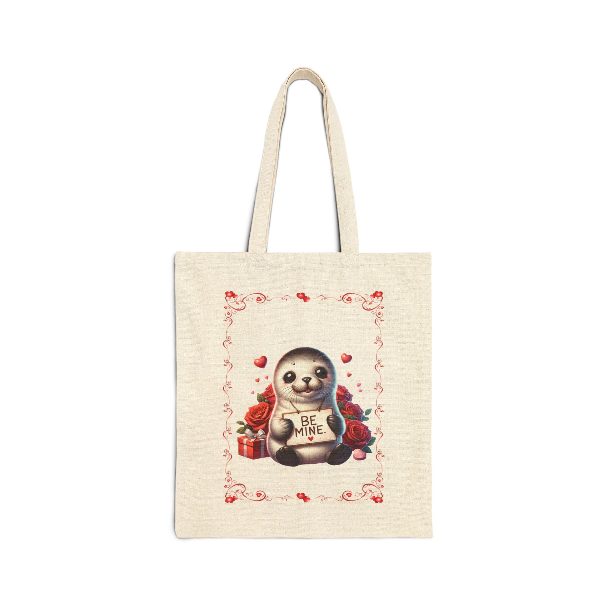Canvas tote bag with a "Be Mine" print featuring a cute baby seal surrounded by red roses and hearts.


