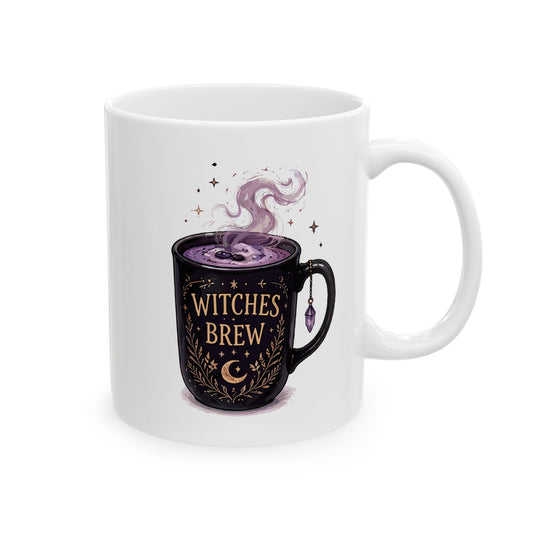 White ceramic coffee mug featuring an illustration of a black cup labeled WITCHES BREW filled with steaming purple liquid and decorated with a crescent moon, stars, and a purple crystal charm hanging from its handle.