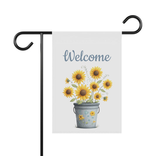 Summer garden flag featuring bright yellow sunflowers blooming in a blue vintage bucket beneath blue script text reading Welcome.