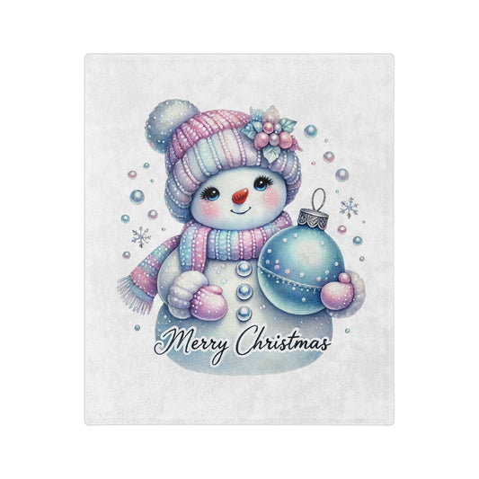 Cute pastel snowman in knit hat and scarf holding Christmas ornament with “Merry Christmas” text