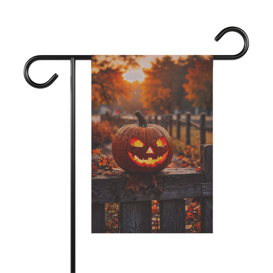 “Glowing jack-o’-lantern on rustic wooden fence at sunset – Halloween garden flag with autumn background”