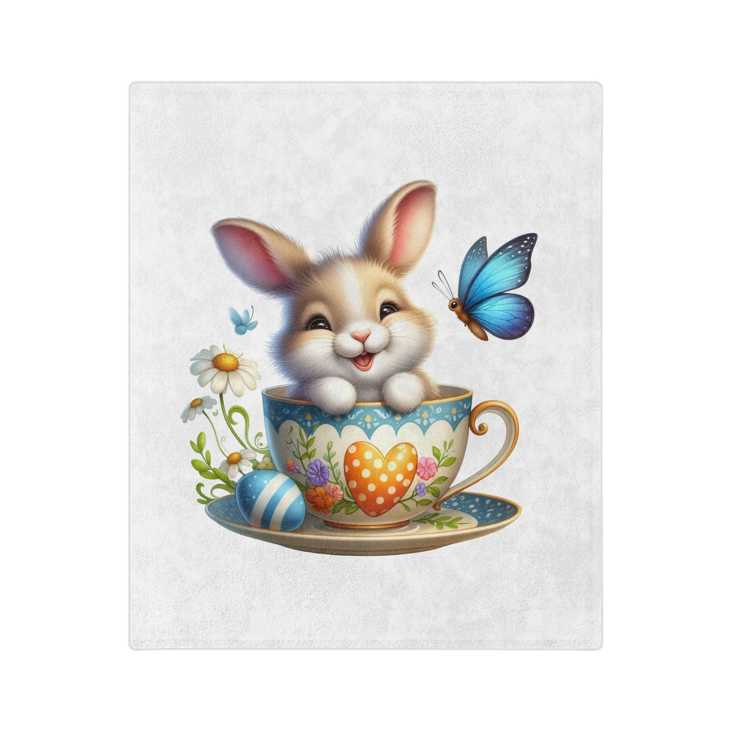 "Close-up of a lightweight velveteen blanket featuring an adorable cartoon brown and white bunny with big eyes and a wide smile, peeking out of a light blue and white patterned teacup. The teacup has an orange polka-dotted heart on its side. To the left of the teacup are white daisy flowers with yellow centers and a blue striped Easter egg. A vibrant blue butterfly is flying above the teacup on the right, and a smaller blue butterfly is on the left. 