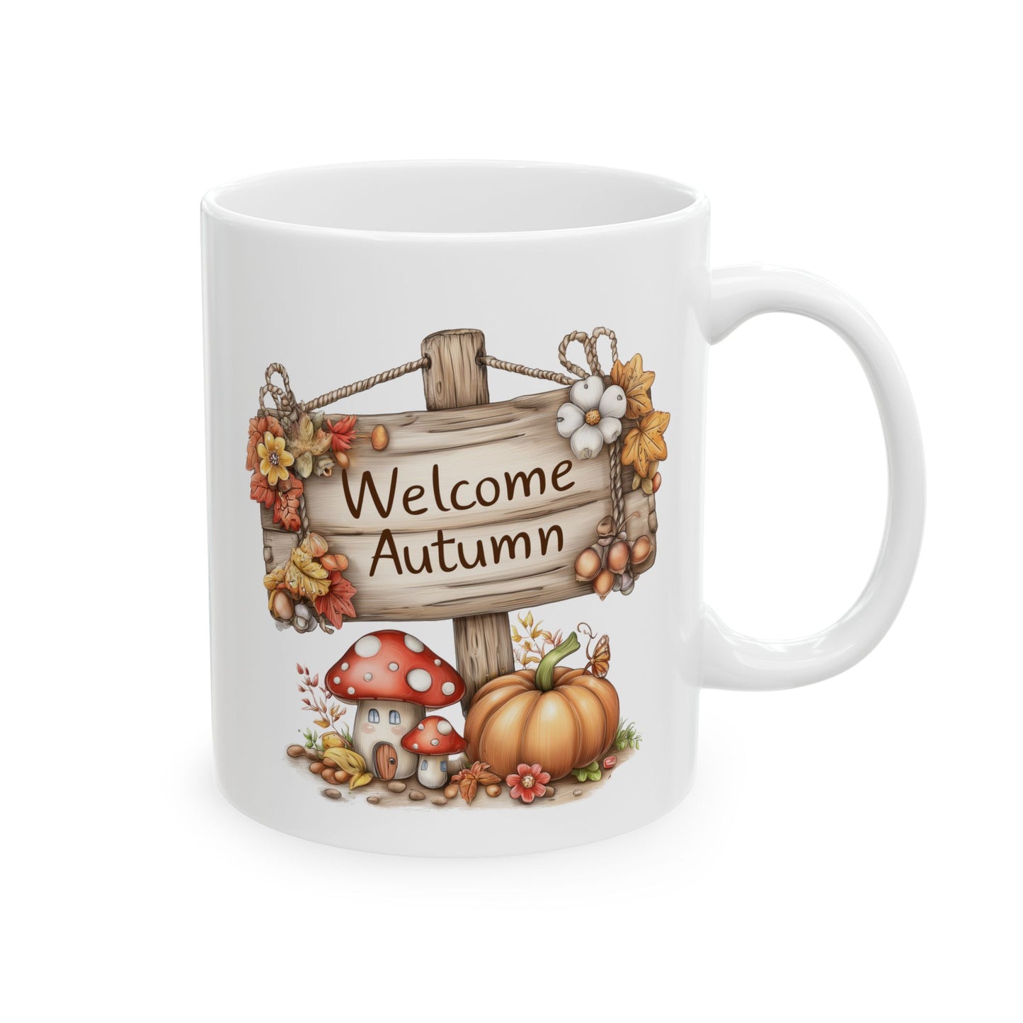 White ceramic coffee mug featuring a whimsical autumn illustration of a tiny mushroom house with a door, a pumpkin, and a wooden sign that reads Welcome Autumn.