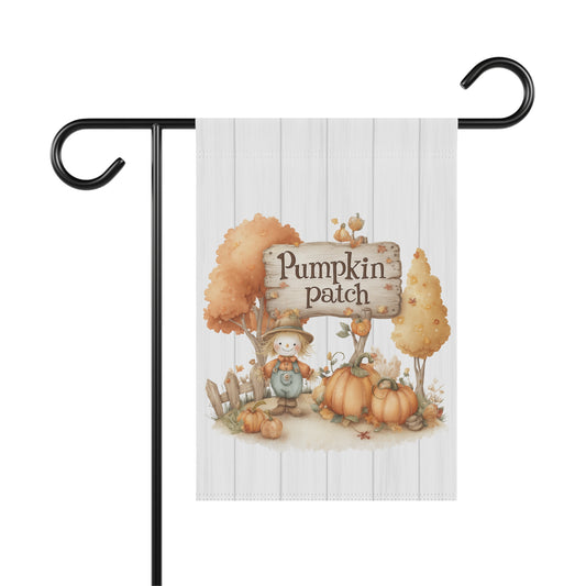 Whimsical autumn garden flag with a white shiplap wood background, featuring a friendly scarecrow next to a wooden sign that says Pumpkin Patch, surrounded by pumpkins, autumn trees, and a small fence.