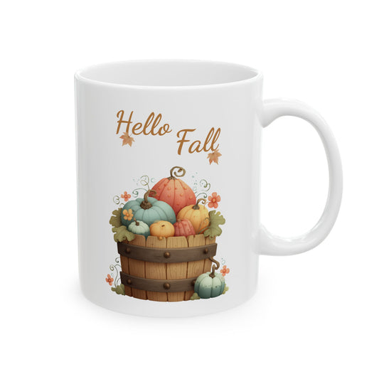 White ceramic coffee mug featuring a colorful autumn illustration of a rustic wooden barrel filled with coral, teal, and yellow pumpkins under the words Hello Fall.
