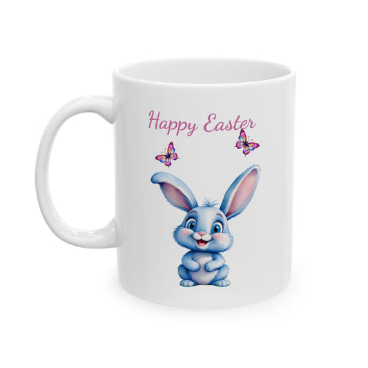 White ceramic mug with "Happy Easter" text in pink, featuring a cute smiling light blue cartoon bunny sitting below two colorful butterflies.

