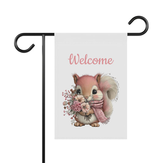 Spring garden flag featuring an adorable pink-toned squirrel wearing a plaid scarf and holding a bouquet of wildflowers beneath pink script text reading Welcome.