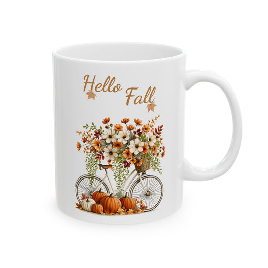 White ceramic mug featuring autumn vintage bicycle illustration beneath warm brown script text reading Hello Fall.