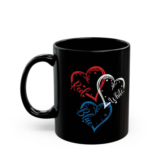 Black ceramic coffee mug with three outlined hearts in red, white, and blue, each labeled with 'Red', 'White', and 'Blue' text, symbolizing patriotic colors