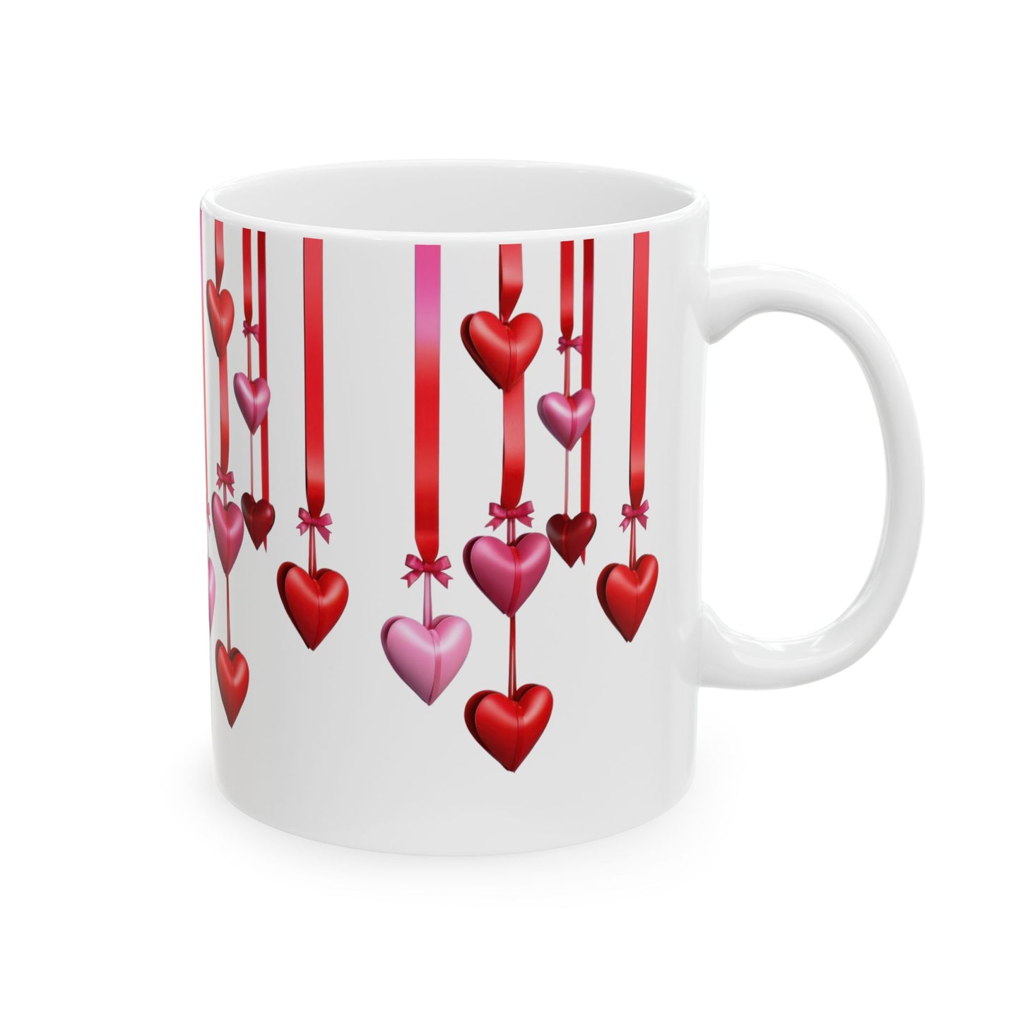 White ceramic coffee mug with a wraparound design of numerous red and pink heart shapes hanging from vertical red ribbons