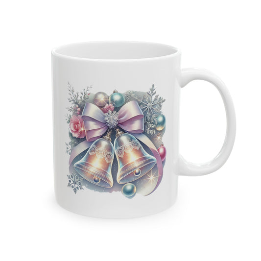 White ceramic coffee mug printed with an illustration of two silver Christmas bells adorned with a pastel pink bow, pine branches, and ornaments
