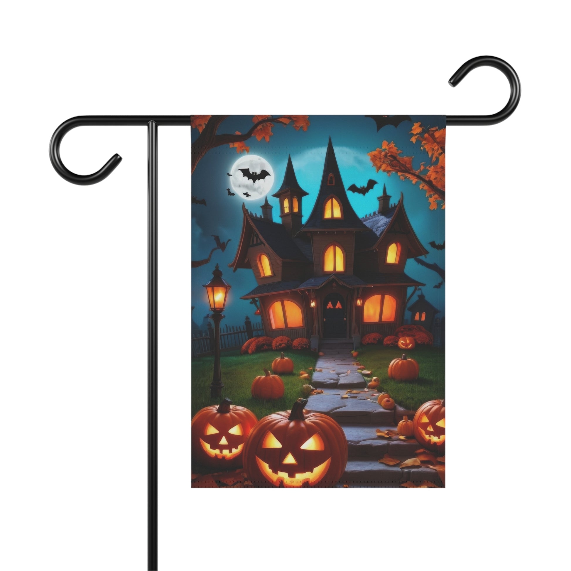 Halloween garden flag showing a haunted house with lit windows, a street lamp, a path lined with jack-o'-lanterns, bats, and a full moon in a blue night sky.