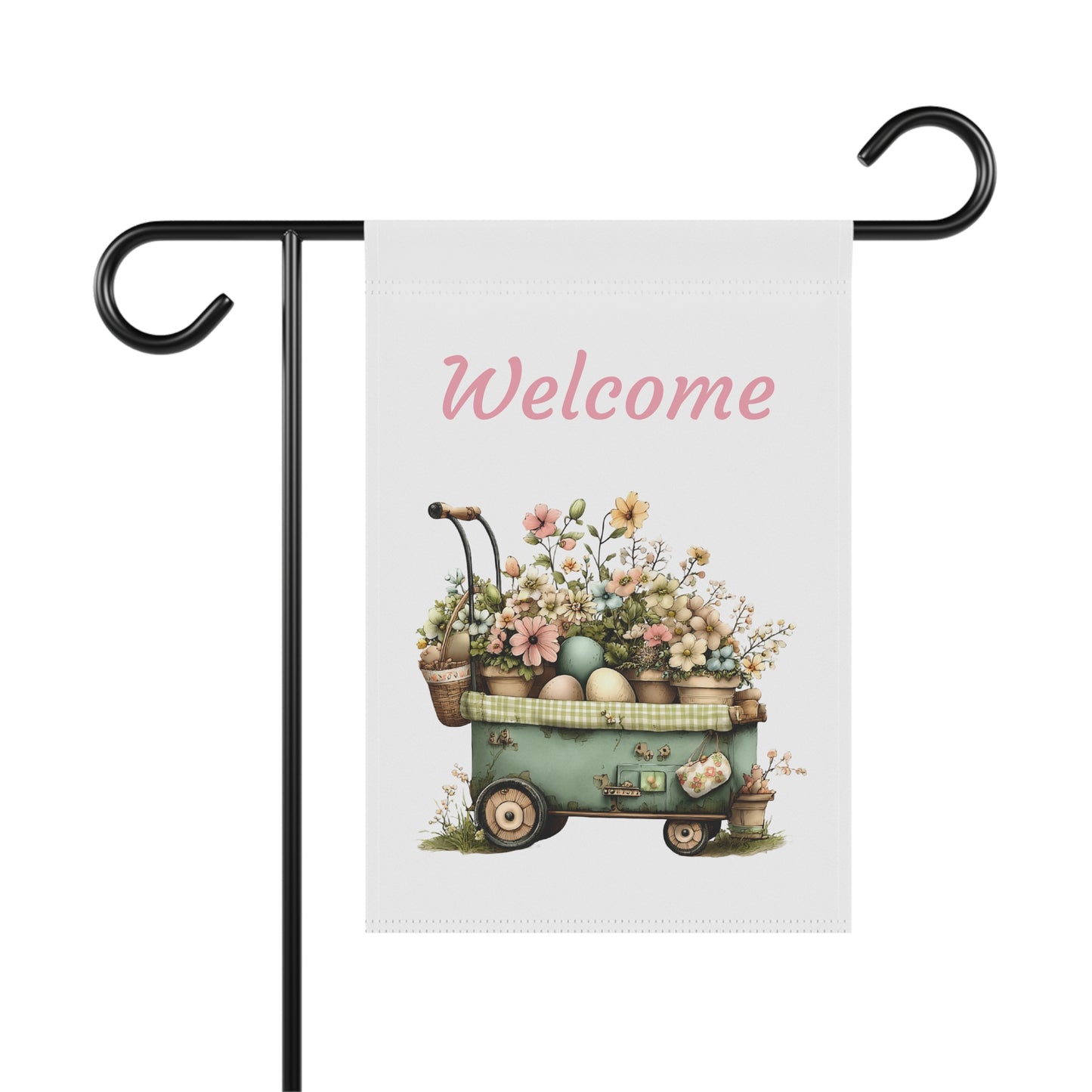 Garden flag on a black metal stand printed with soft pink script Welcome text above a vintage garden cart overflowing with potted flowers