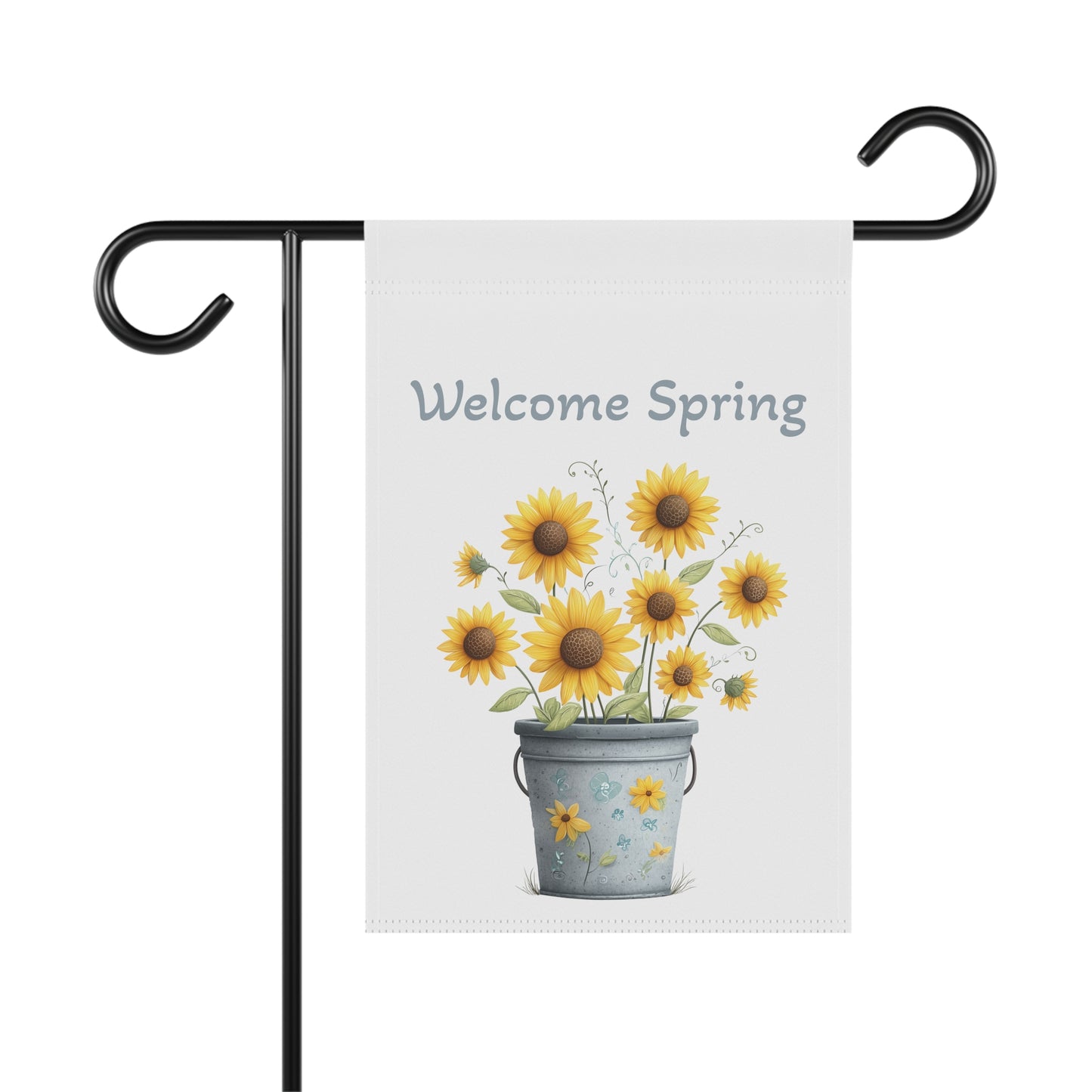 Bright yellow sunflowers blooming out of a decorative bucket under blue Welcome text garden flag