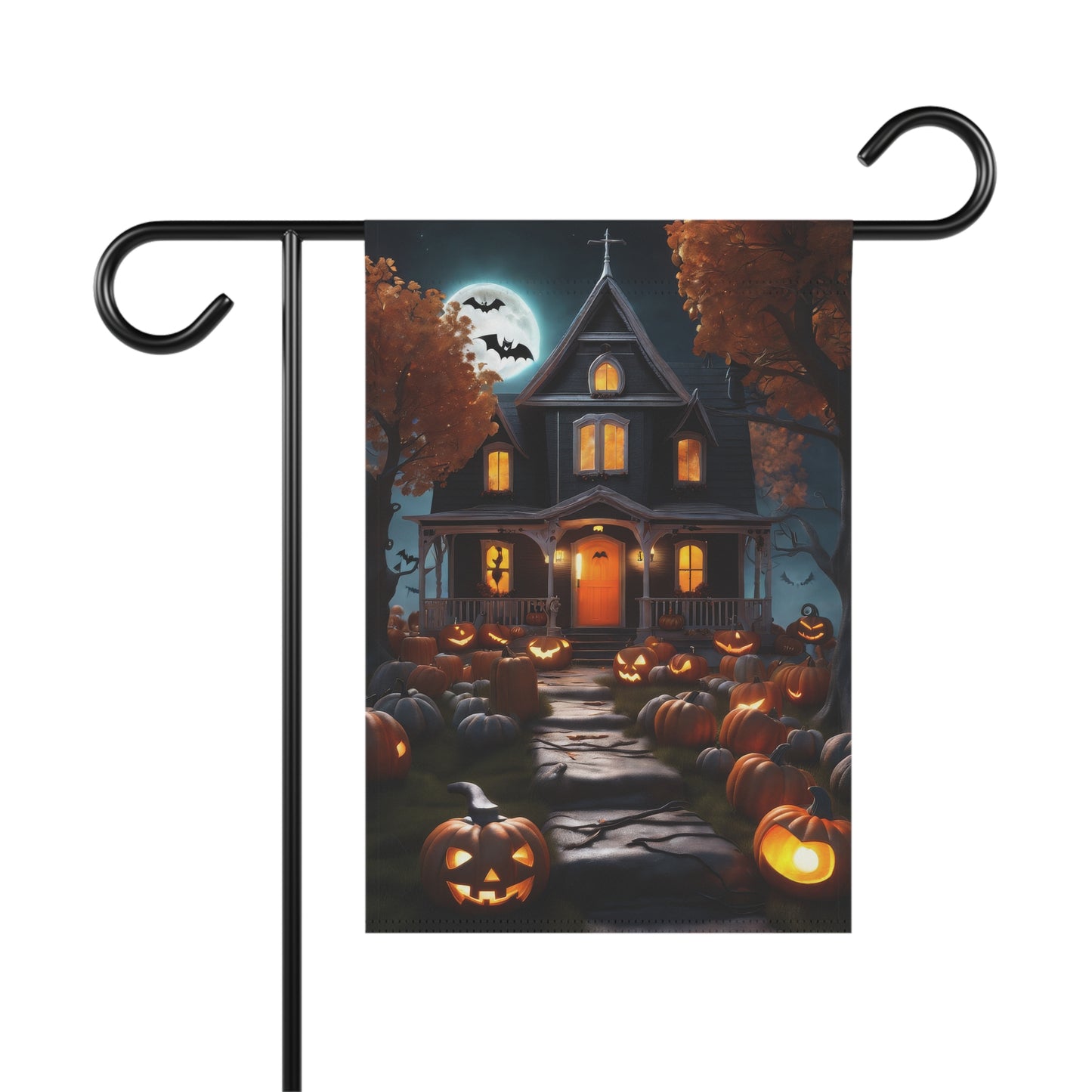 Haunted house with glowing jack-o'-lanterns lining a stone pathway under a full moon on Halloween garden flag

