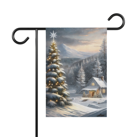 Winter wonderland garden flag with a snow-covered cabin, illuminated Christmas tree with a star, snowy pine trees, and distant mountains, on a black metal garden flag stand.

