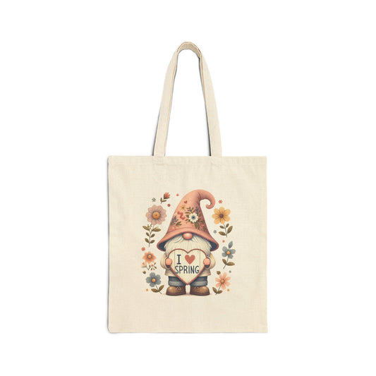 Canvas tote bag with a watercolor-style print of a garden gnome with a pink floral hat, holding a heart that says "I Love Spring."