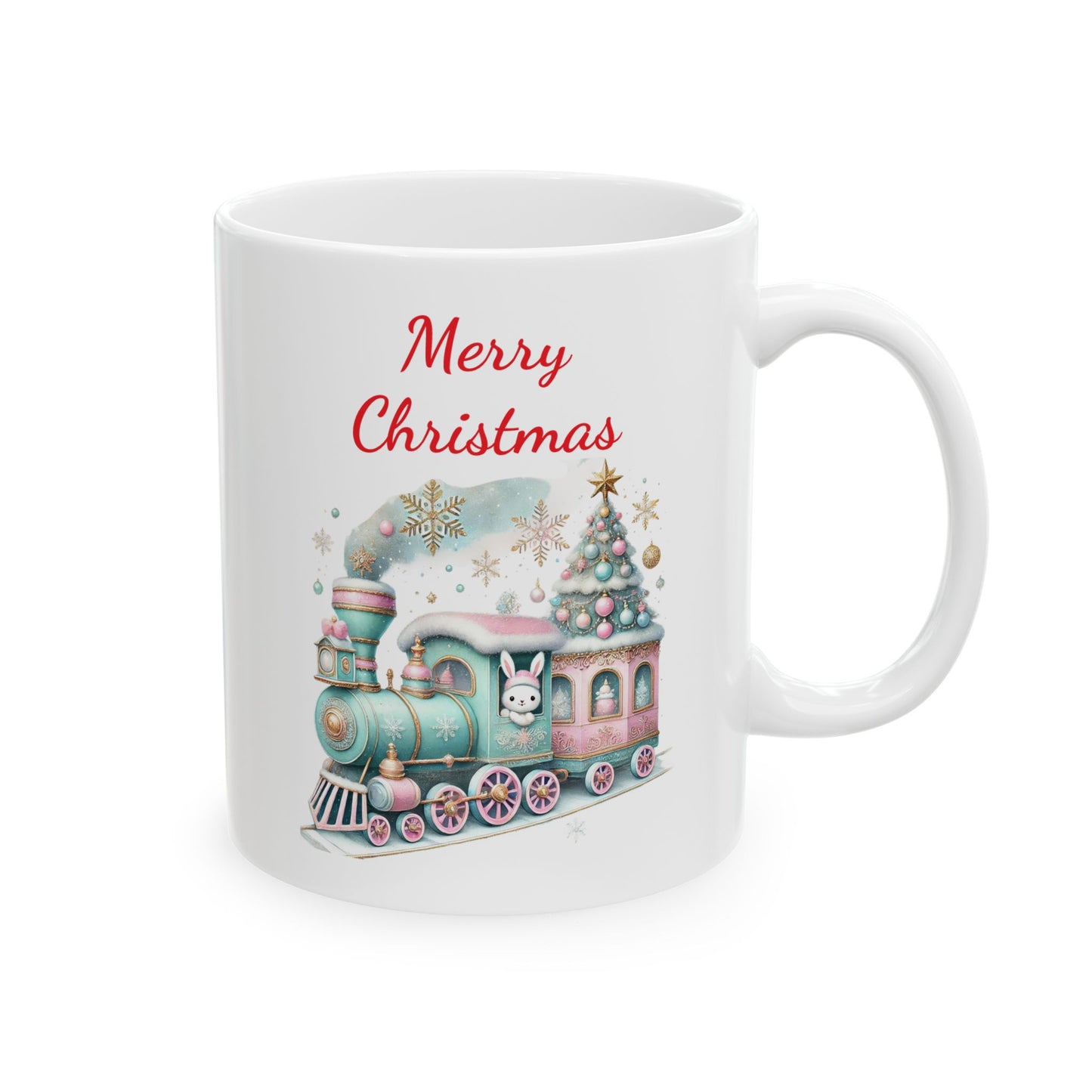 White ceramic coffee mug with a watercolor illustration of a light blue and pink Christmas train carrying a decorated Christmas tree and a white bunny, with red "Merry Christmas" text above.
