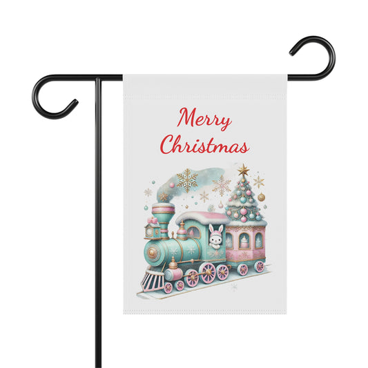 Merry Christmas garden flag with a pastel pink and blue holiday train, decorated Christmas tree, bunny, and snowflakes, whimsical festive outdoor decor.

