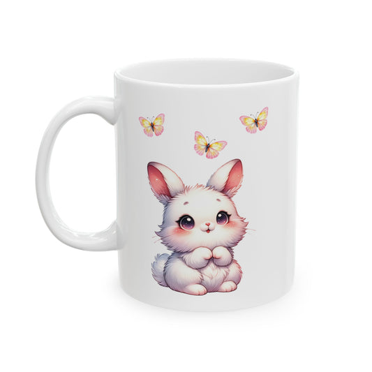 White ceramic mug with an adorable fluffy white cartoon bunny with pink ears and cheeks, sitting below three colorful pink and yellow butterflies.

