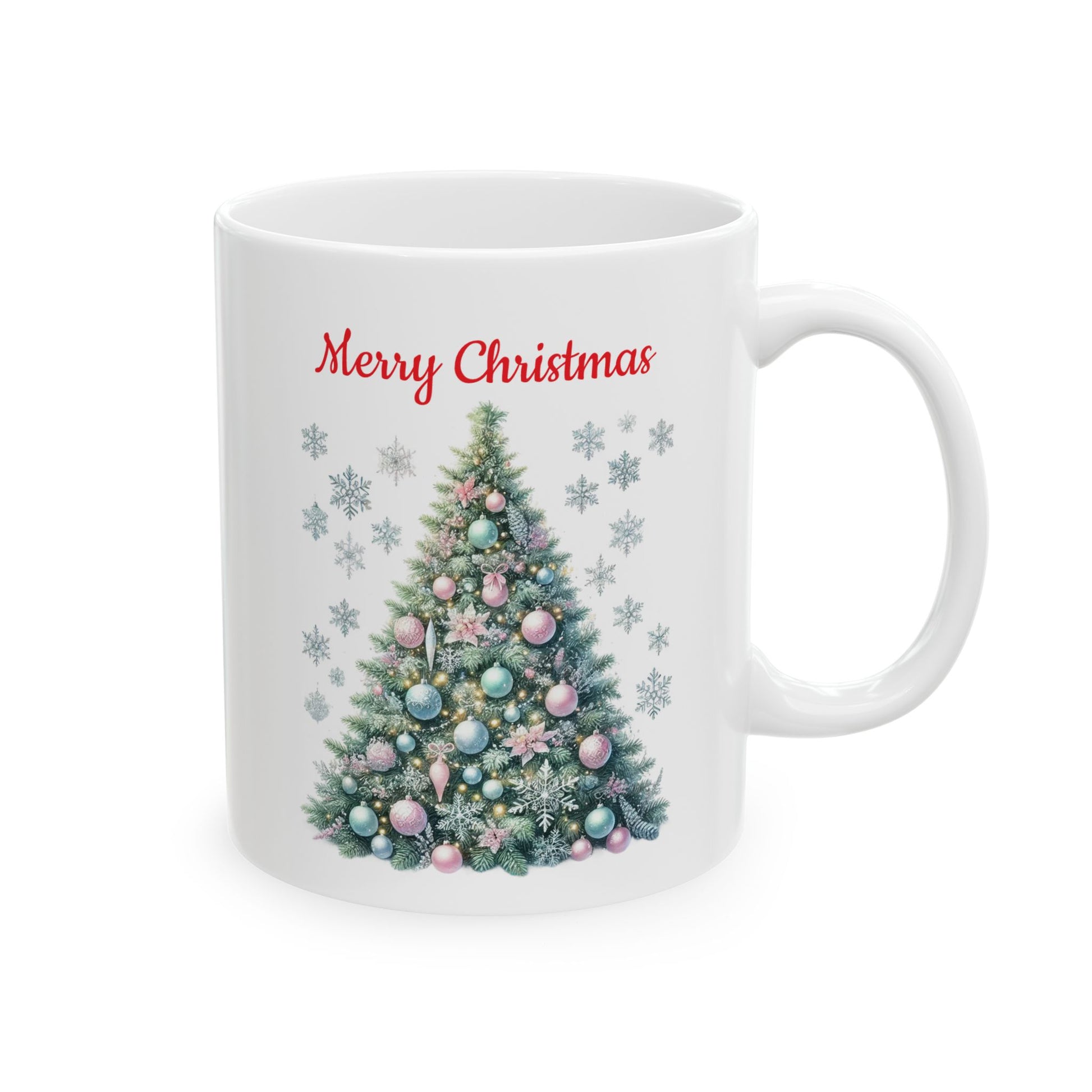 White ceramic coffee mug with a watercolor illustration of a decorated green Christmas tree with pink, blue, and silver ornaments, surrounded by silver snowflakes, with red "Merry Christmas" text above.