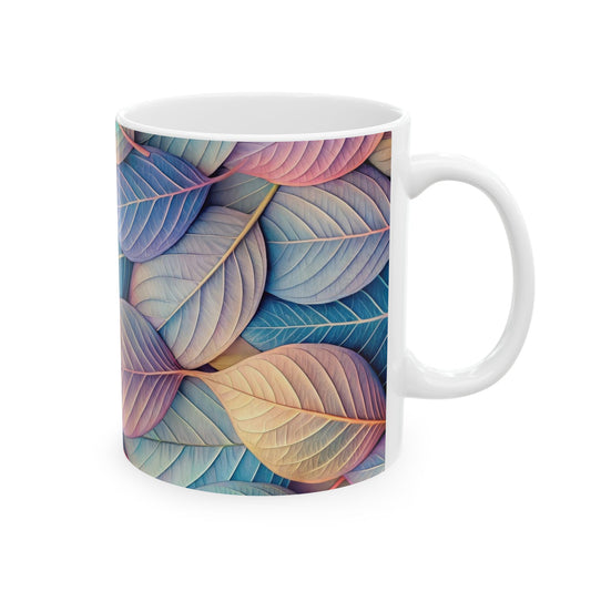 White ceramic coffee mug with a wrap-around pattern of pastel blue, pink, and yellow leaves.

