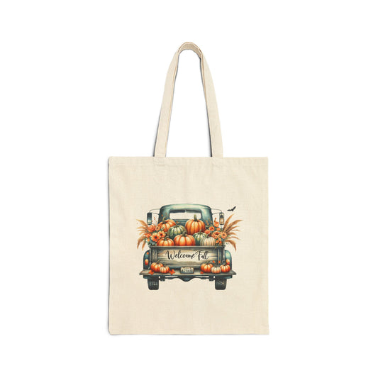 Cream-colored canvas tote bag featuring a vintage blue pickup truck filled with pumpkins and fall leaves, with the text "Welcome Fall"