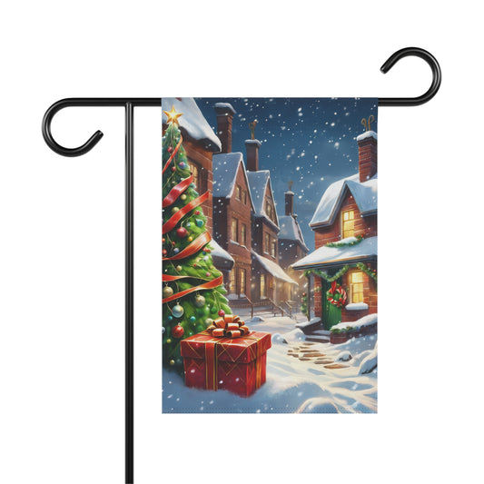 Cozy Christmas street garden flag with snow-covered houses, a decorated Christmas tree with red ribbon, and a red present in a snowy village scene, on a black metal garden flag stand.

