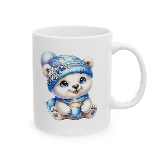 White ceramic coffee mug printed with an illustration of a cute white polar bear cub in a blue snowflake beanie holding a small steamy mug of coffee