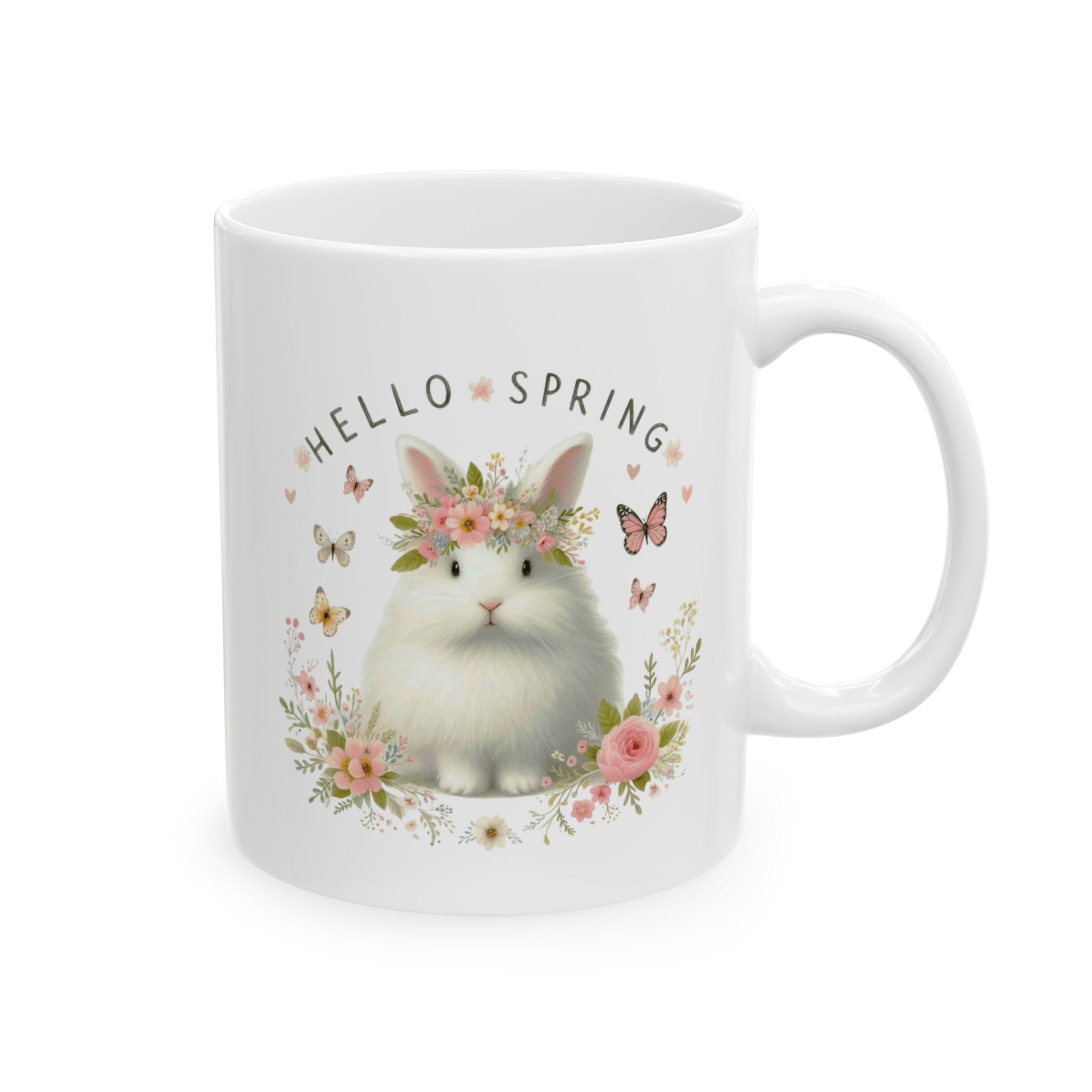 Front view of a white ceramic coffee mug featuring a cute, fluffy white rabbit wearing a floral crown and the text "HELLO SPRING."