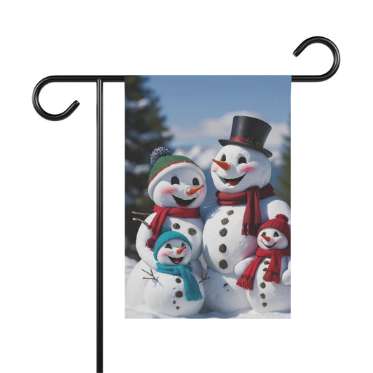 Happy snowman family garden flag with two adult snowmen and two child snowmen wearing hats and scarves in a snowy mountain landscape, cheerful winter outdoor decor.

