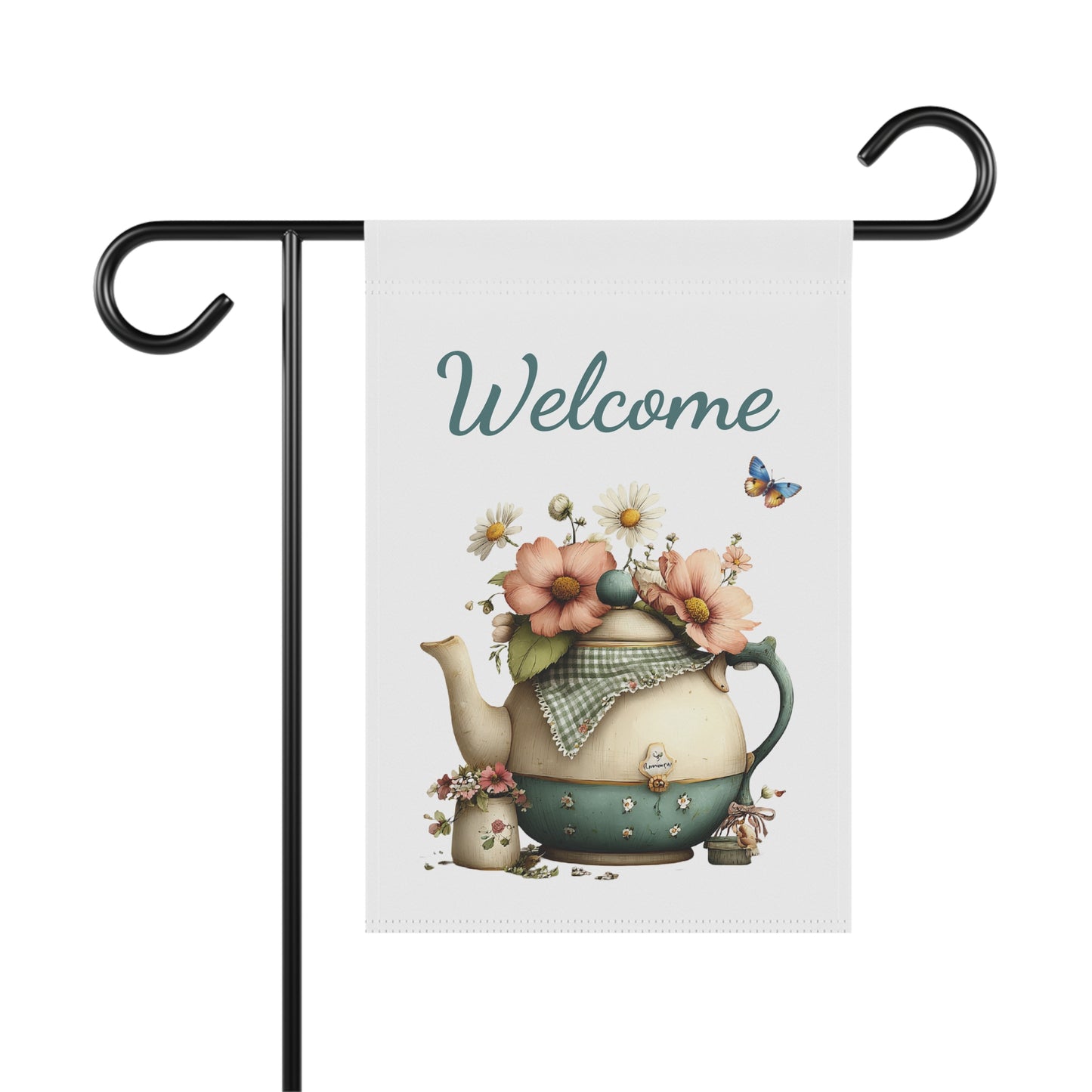 Garden flag on a black metal stand printed with teal script Welcome text above a vintage teapot overflowing with garden flowers