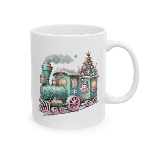 White ceramic coffee mug printed with a pastel mint green and pink Christmas express train featuring a cute snowman passenger and pastel decorated tree