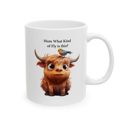 Image Alt Text:
White ceramic coffee mug with a cartoon illustration of a cute, fluffy brown baby Highland cow with large eyes and horns, with a small colorful bird perched on its head. Black text above reads "Mom What Kind of Fly is this?".