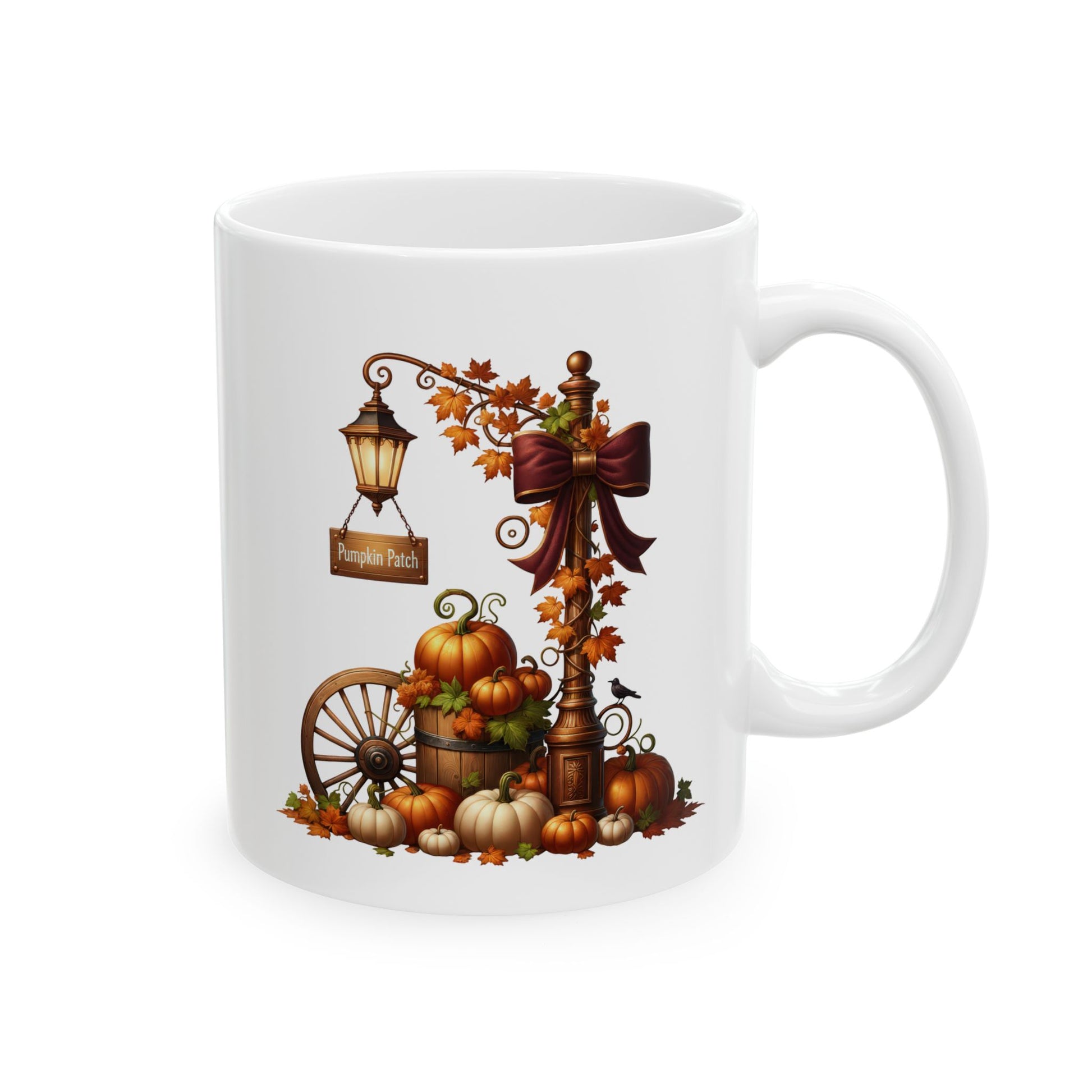 White ceramic coffee mug featuring an elegant autumn illustration of a vintage lamppost with a large burgundy bow, a Pumpkin Patch sign, a wooden wagon wheel, and assorted pumpkins.