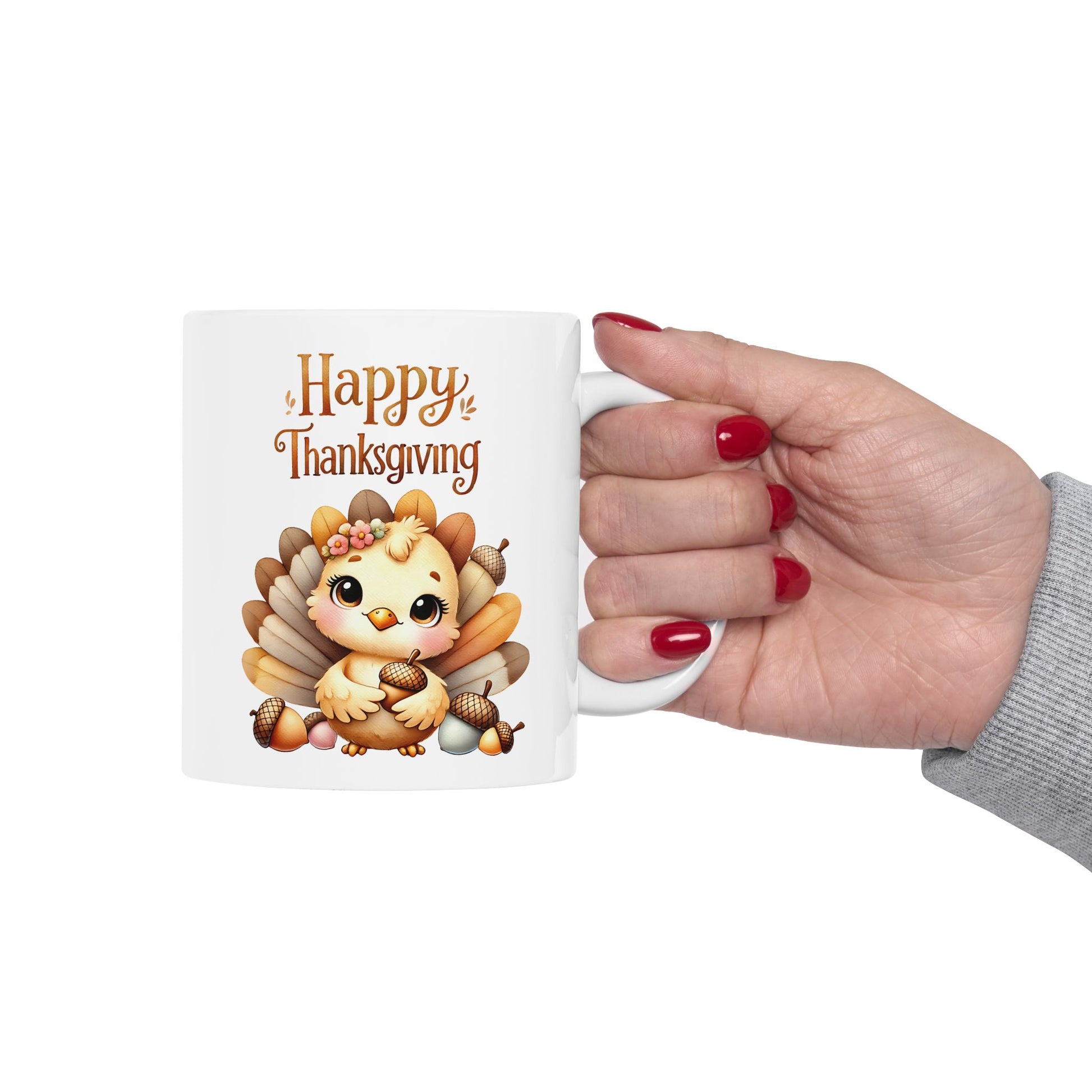 White ceramic mug with cute cartoon turkey holding acorns and "Happy Thanksgiving" text, on a wooden table with green plants

