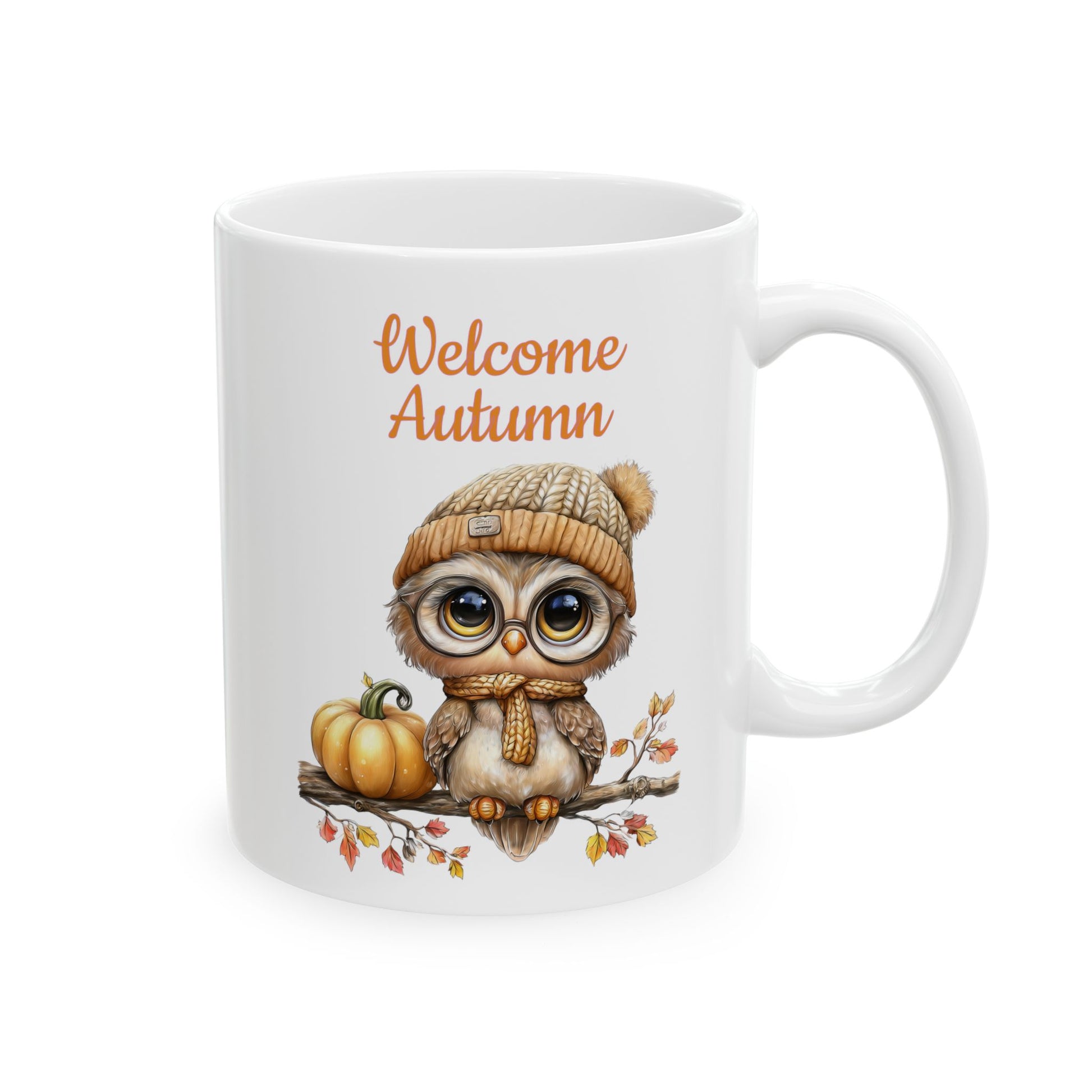 Welcome Autumn ceramic coffee mug featuring a cute illustration of a baby owl wearing glasses, a knit hat, and a scarf, sitting on a branch next to a pumpkin with autumn leaves.