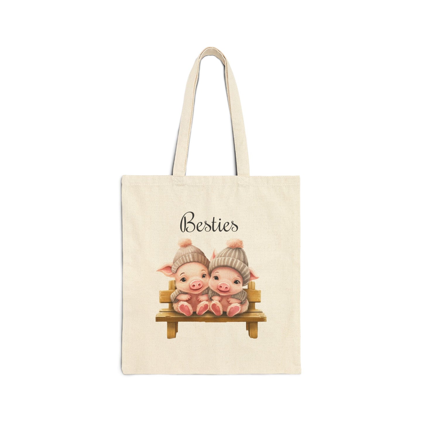 "Besties" canvas tote bag with two cute baby pigs sitting on a bench wearing matching knit hats.