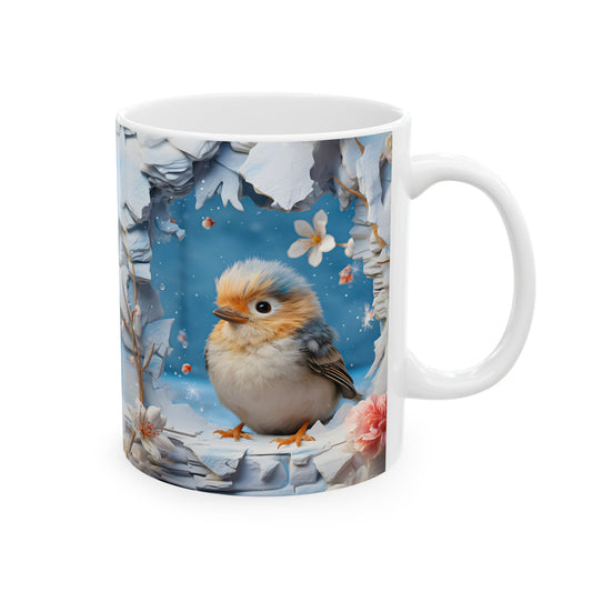 White ceramic coffee mug with a 3D-style illustration of a cute, fluffy bird with blue and orange feathers, sitting in a snowy, icy frame with pink and white winter flowers and snowflakes.