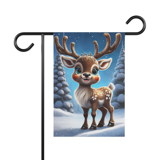 Adorable smiling reindeer garden flag with big antlers and rosy cheeks, in a snowy forest with frosted pine trees, on a black metal garden flag stand.

