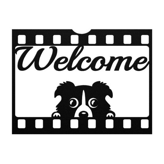 Black metal sign featuring a playful puppy and the word "Welcome" within a movie film reel frame on a gray background.

